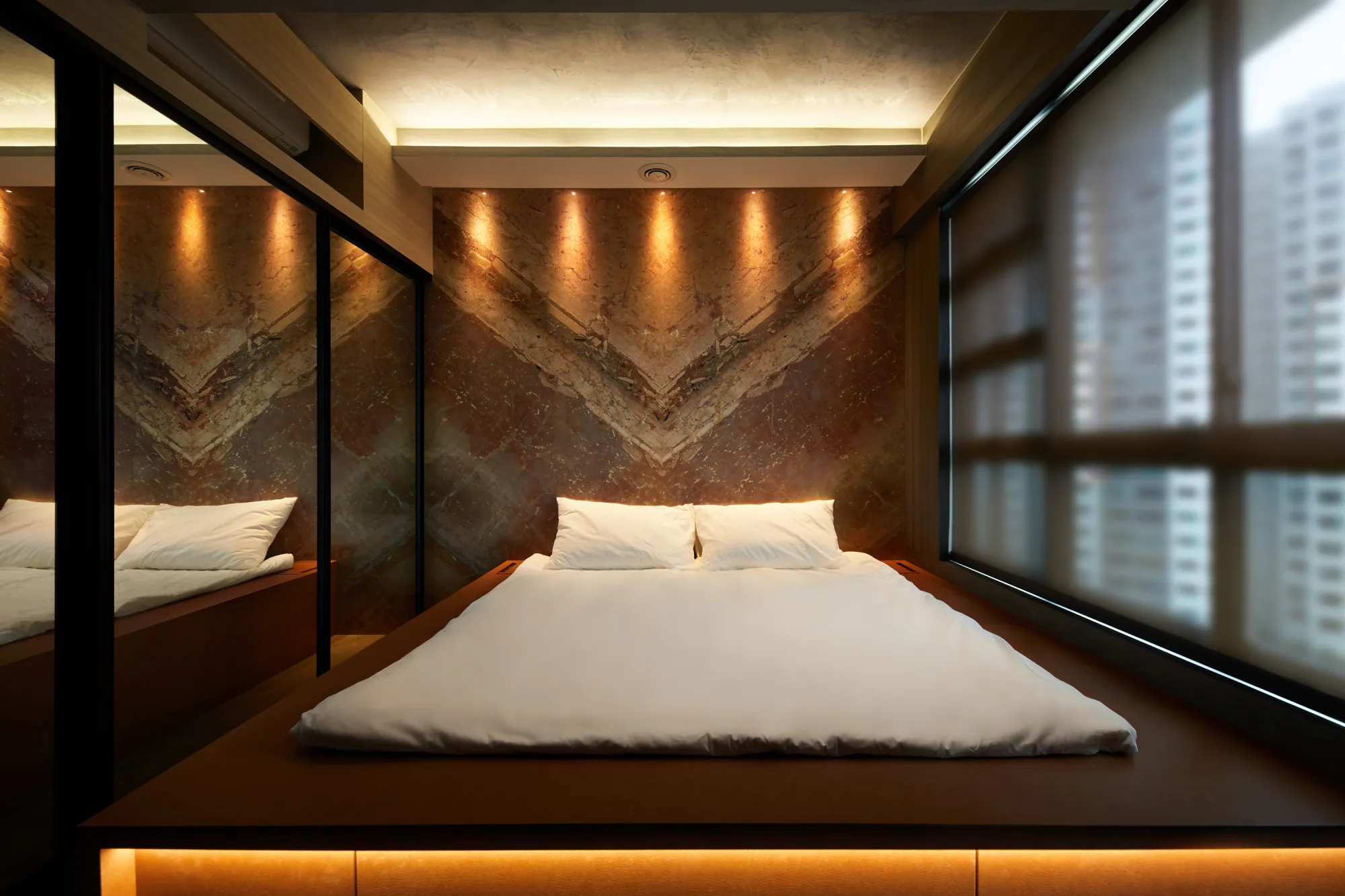 2-room BTO interior design with cozy bedroom featuring marble accent wall and soft ambient lighting from ceiling and bedside panels