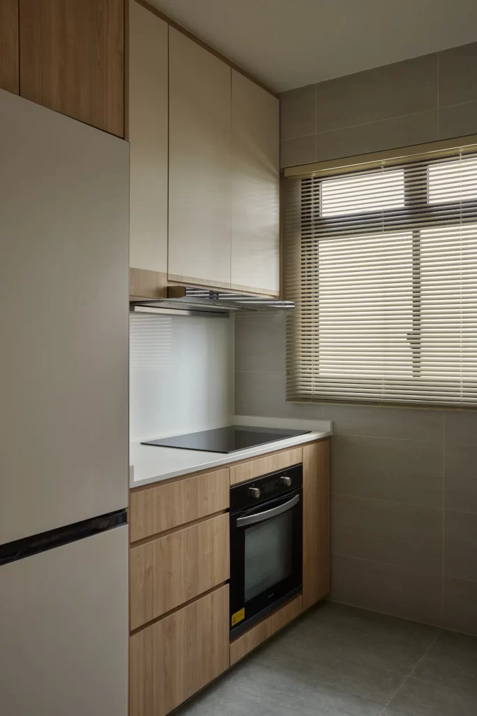 Compact BTO kitchen design with built-in oven, induction hob, and overhead cabinets