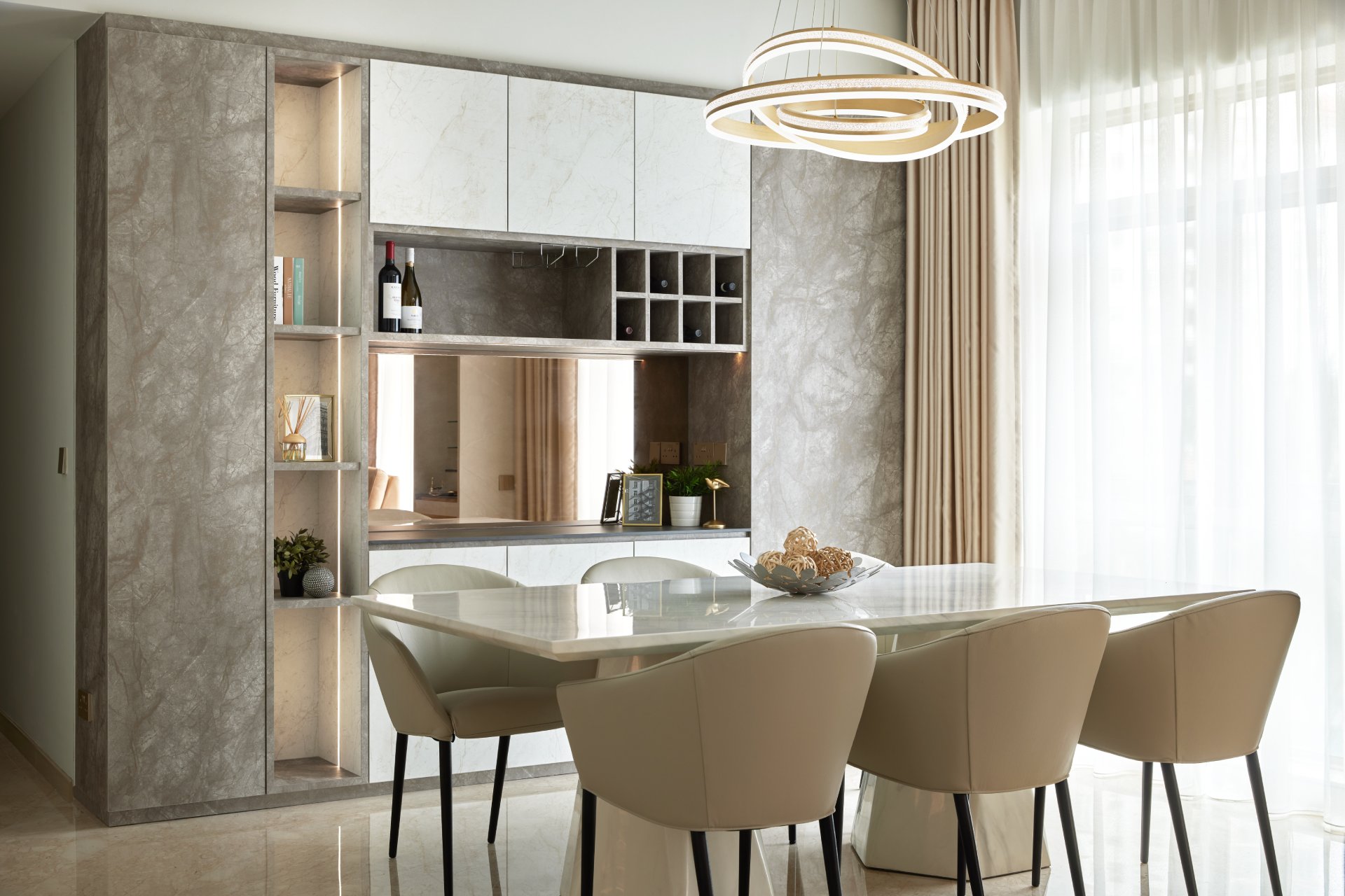 Modern condo dining area with marble-top table and beige upholstered chairs