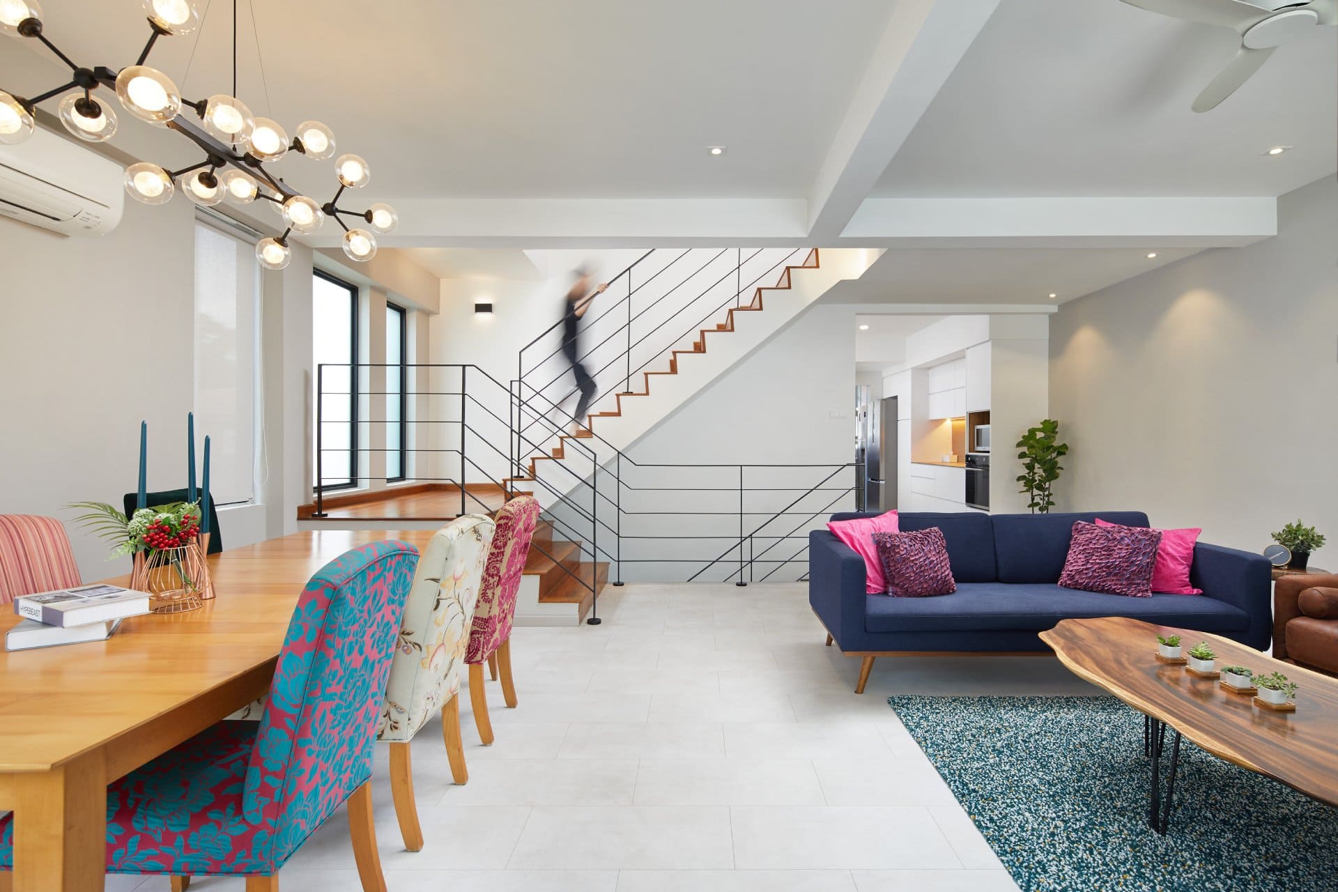 Modern open-concept living space with dining area and staircase