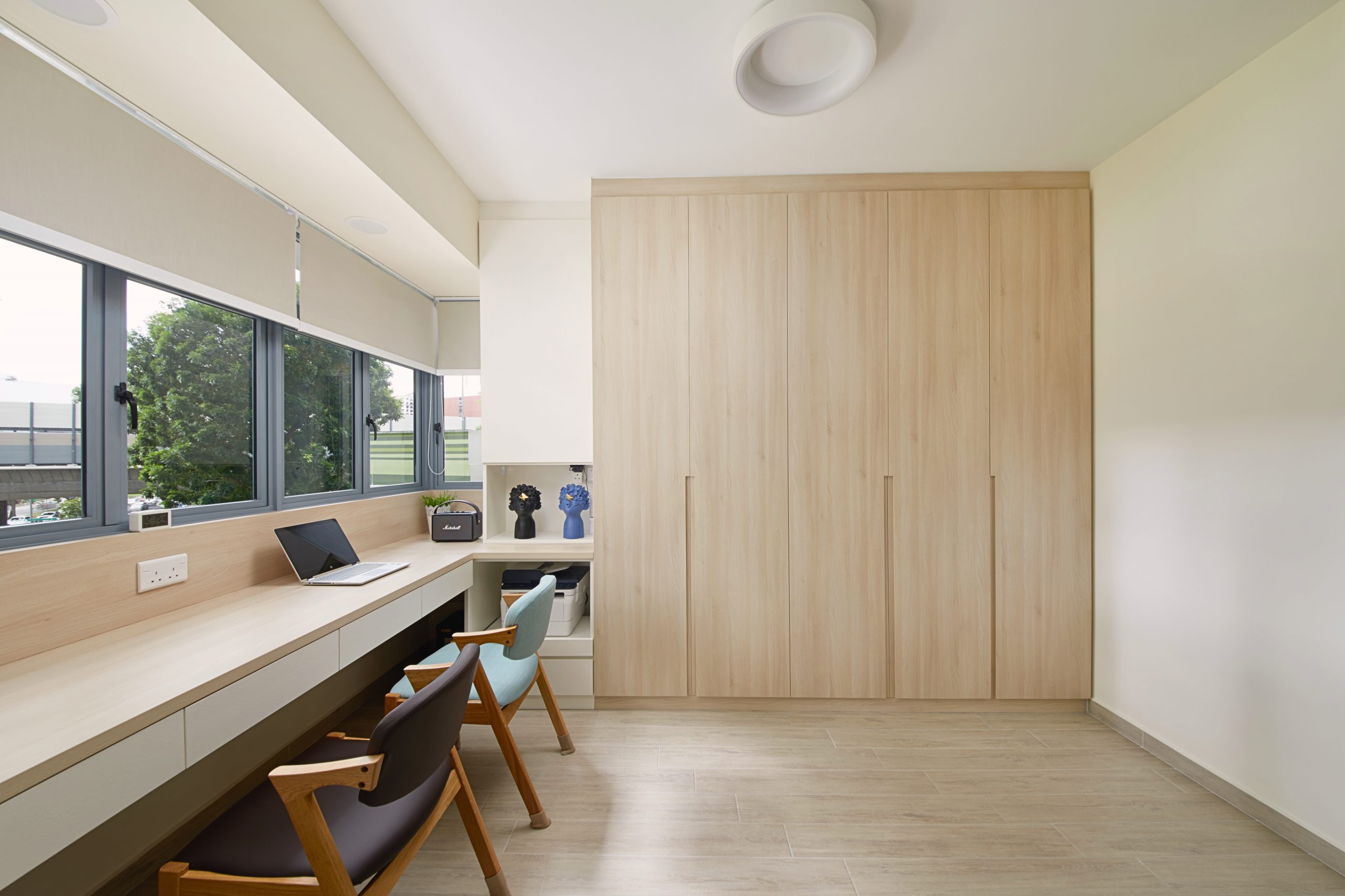 Japandi-inspired study room with light wood cabinetry, built-in desk and soft daylight.