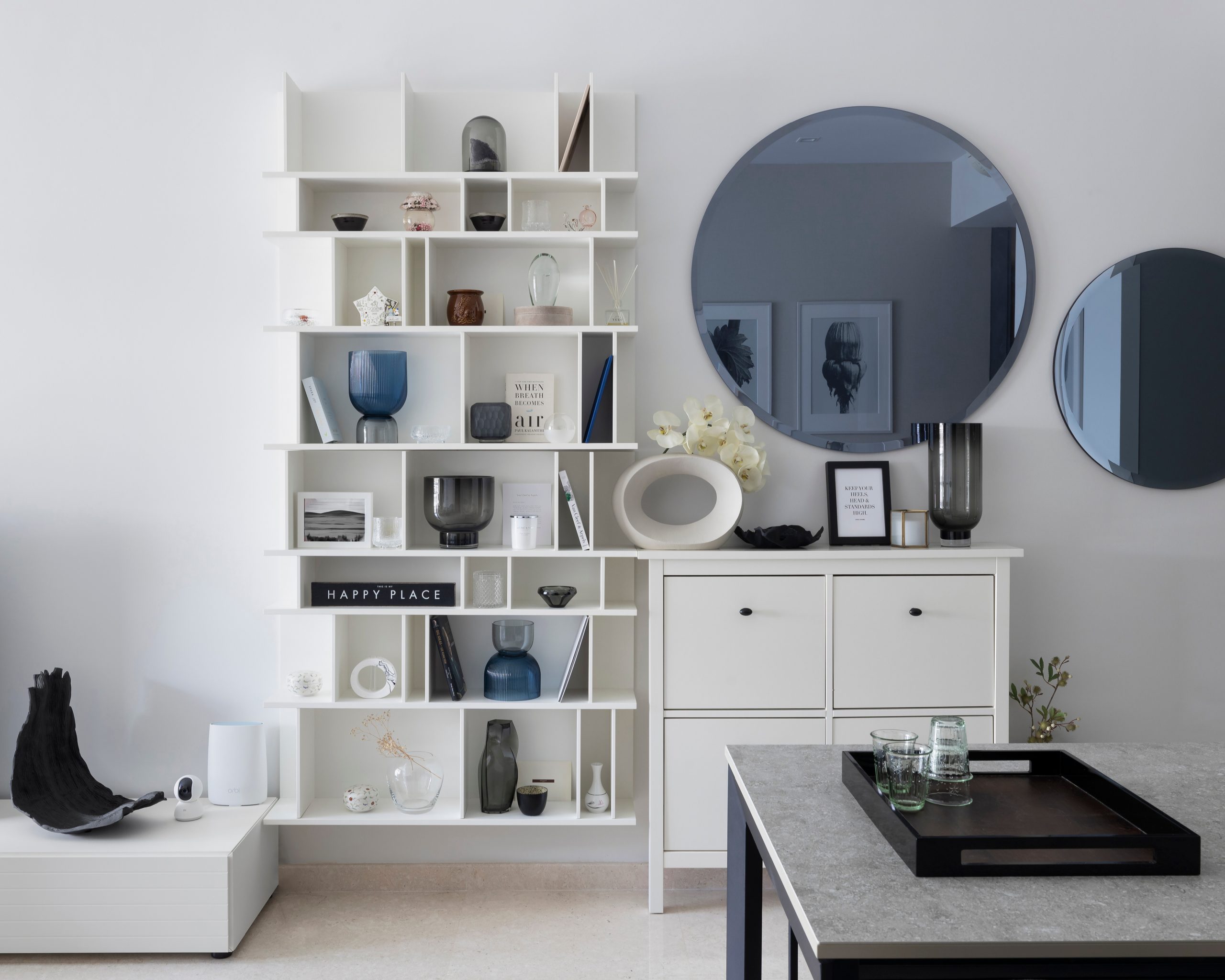 Modern white shelving and console styling with curated décor in a soft contemporary Singapore home