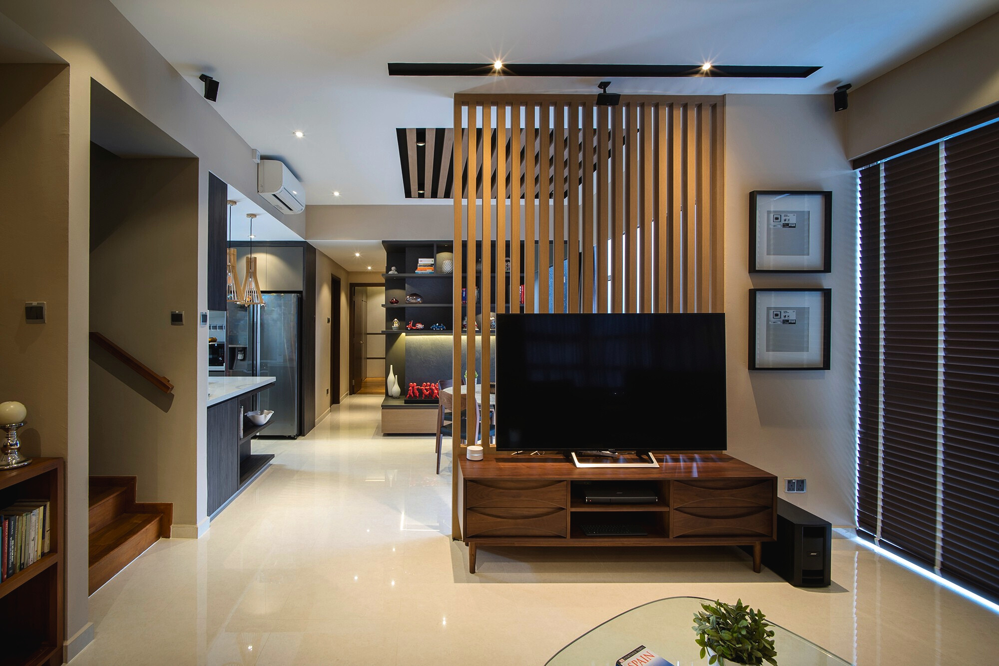 Modern living room with wooden slatted divider and TV console