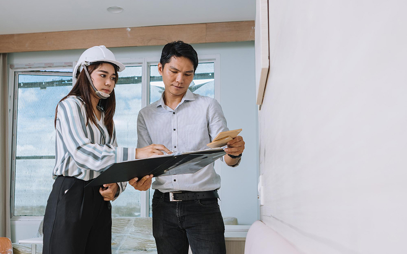 Home designers discussing renovation plans for an HDB.