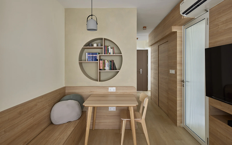 Practical Japandi HDB living room with wood cabinetry.