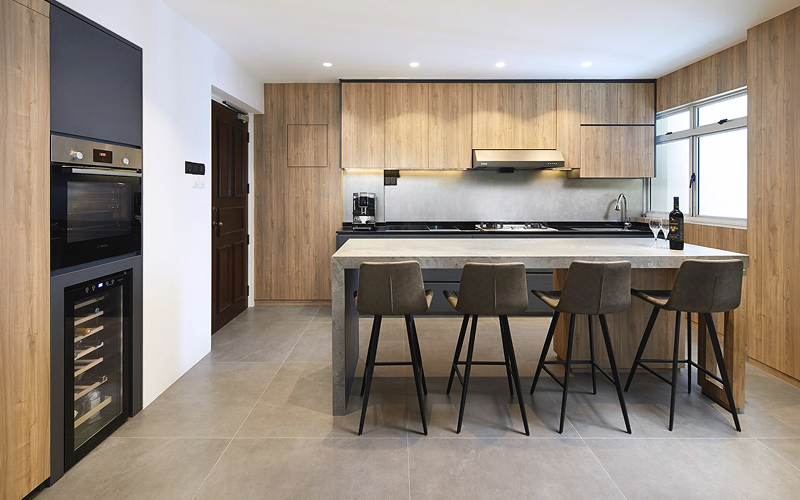 Modern luxury HDB kitchen with wood cabinets and stone island.