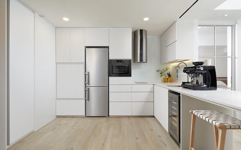 Sleek minimalist kitchen interior in a Singapore luxury condo.
